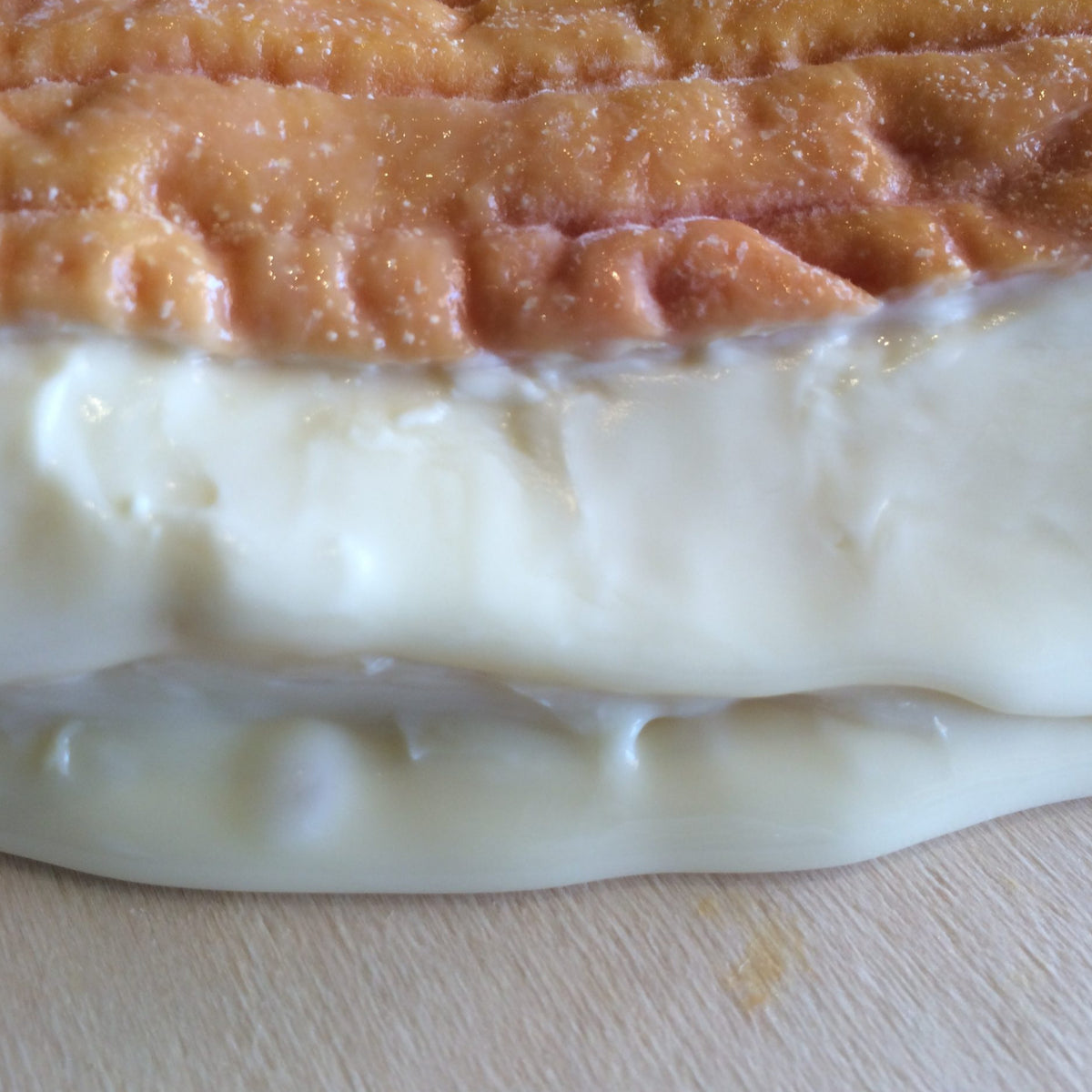 RUNNY CHEESE WITH ORANGE BROWN RIND